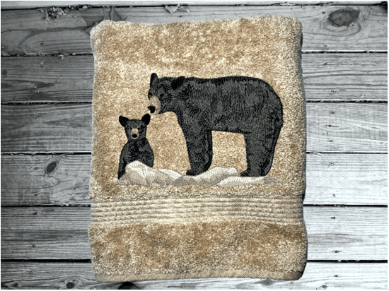 Beige bath towel, embroidered bear design the perfect design for the outdoor living family. This Luxury theme towel set of 3 towels 1 bath towel 27" x 50", 1 hand towel 16" x 27", 1 wash cloth 13" x 13". You can personalize the towel set with a name and name on the washcloth or just designs. Borgmanns Creations 