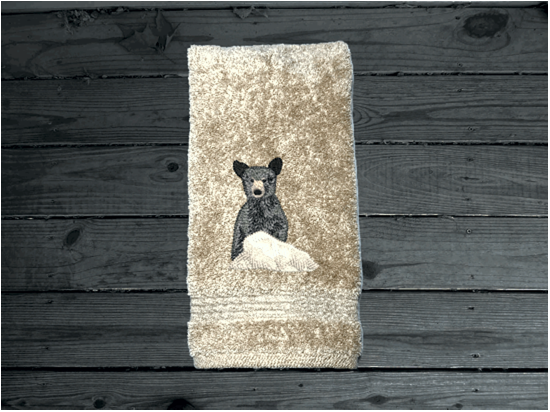 Beige hand towel, embroidered bear design the perfect design for the outdoor living family. This Luxury theme towel set of 3 towels 1 bath towel 27" x 50", 1 hand towel 16" x 27", 1 wash cloth 13" x 13". You can personalize the towel set with a name and name on the washcloth or just designs. Borgmanns Creations 