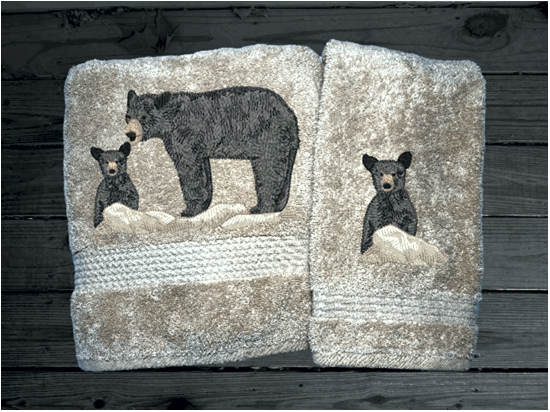Beige bath towel  and hand towel, embroidered bear design the perfect design for the outdoor living family. This Luxury theme towel set of 3 towels 1 bath towel 27" x 50", 1 hand towel 16" x 27", 1 wash cloth 13" x 13". You can personalize the towel set with a name and name on the washcloth or just designs. Borgmanns Creations 