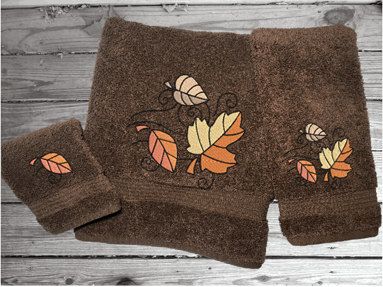 Brown bath towel set or individual towels, Fall leaves is the perfect design for the country living family, that likes the outdoor life, for that farmhouse decor. This Luxury western theme towel set of 3 towels 1 bath towel 27" x 55", 1 hand towel 16" x 27", 1 wash cloth 13" x 13". You can personalize the towel set with a name and an initial on the wash cloth or just the designs. Borgmanns Creations
