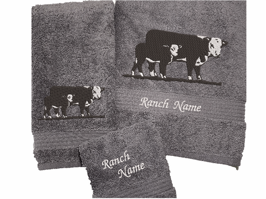 Gray bath towel set or individual towels, Hereford Cow design display with your ranch name embroidered on it. Just the towel set for the western living family, that farmhouse decor. This Luxury towel set of 3 towels 1 bath towel 27" x 50", 1 hand towel 16" x 27", 1 wash cloth 13" x 13". Personalize the towel set with a name and an initial - Borgmanns Creations