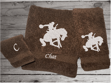Load image into Gallery viewer, Brown High Quality Luxury Turkish Towels durable soft and absorbent, finished edges with a decorative band. Set has 1 bath towel, 1 hand towel, 1 washcloth. Embroidered with a custom design of a bronc rider. You can personalize the towel set with a name and an initial on the washcloth or just the designs. These luxury towels will make a wonderful hostess towel, wedding gift, housewarming gift, or for your own bathroom decor. Borgmanns Creations - 1
