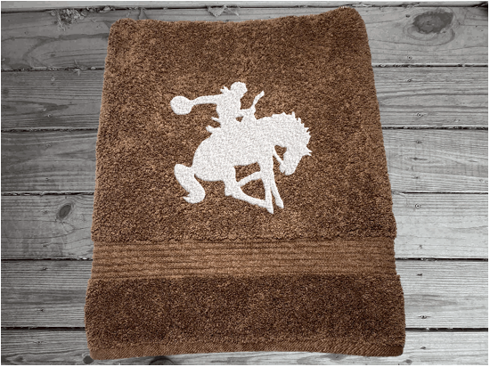 Brown  bath towel high quality luxury Turkish Towels durable soft and absorbent, finished edges with a decorative band. Set has 1 bath towel, 1 hand towel, 1 washcloth. Embroidered with a custom design of a bronc rider. You can personalize the towel set with a name and an initial on the washcloth or just the designs. These luxury towels will make a wonderful hostess towel, wedding gift, housewarming gift, or for your own bathroom decor. Borgmanns Creations - 3