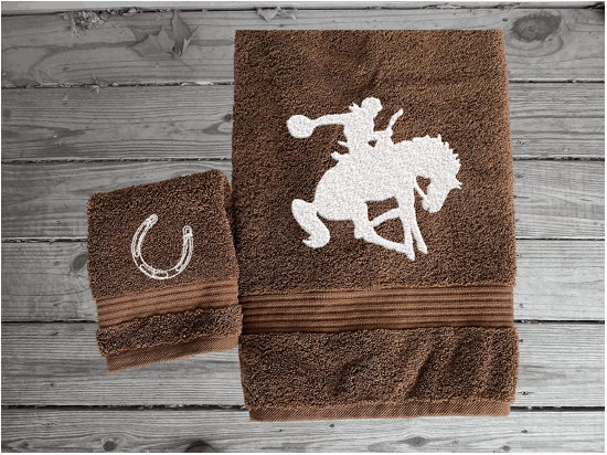 Brown  bath towel and washcloth high quality luxury Turkish Towels durable soft and absorbent, finished edges with a decorative band. Set has 1 bath towel, 1 hand towel, 1 washcloth. Embroidered with a custom design of a bronc rider. You can personalize the towel set with a name and an initial on the washcloth or just the designs. These luxury towels will make a wonderful hostess towel, wedding gift, housewarming gift, or for your own bathroom decor. Borgmanns Creations - 7