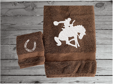 Load image into Gallery viewer, Brown  bath towel and washcloth high quality luxury Turkish Towels durable soft and absorbent, finished edges with a decorative band. Set has 1 bath towel, 1 hand towel, 1 washcloth. Embroidered with a custom design of a bronc rider. You can personalize the towel set with a name and an initial on the washcloth or just the designs. These luxury towels will make a wonderful hostess towel, wedding gift, housewarming gift, or for your own bathroom decor. Borgmanns Creations - 7
