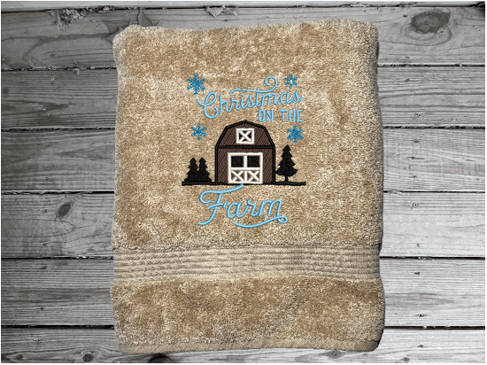 Beige bath towel, embroidered design of a barn at Christmas time, is perfect for for that farmhouse decor. This Luxury soft and absorbent bathroom towel is in a set of 3 towels 1 bath towel 27" x 55", 1 hand towel 16" x27", 1 wash cloth 13" x 13". Housewarming, best friend, or family gift. Borgmanns Creations