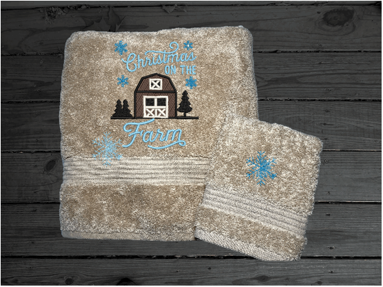 Beige bath towel and washcloth, embroidered design of a barn at Christmas time, is perfect for for that farmhouse decor. This Luxury soft and absorbent bathroom towel is in a set of 3 towels 1 bath towel 27" x 55", 1 hand towel 16" x27", 1 wash cloth 13" x 13". Housewarming, best friend, or family gift. Borgmanns Creations