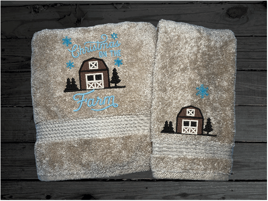 Beige bath towel and hand towel, embroidered design of a barn at Christmas time, is perfect for for that farmhouse decor. This Luxury soft and absorbent bathroom towel is in a set of 3 towels 1 bath towel 27" x 55", 1 hand towel 16" x27", 1 wash cloth 13" x 13". Housewarming, best friend, or family gift. Borgmanns Creations