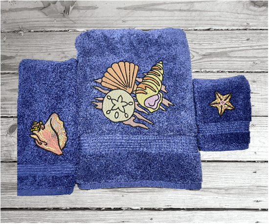 Bue High Quality Luxury Turkish Towels durable soft and absorbent, finished edges with a decorative band. Set has 1 bath towel 27" x 50", 1 hand towel 16" x 27", 1 washcloth 13" x 13". Embroidered with custom sea shells design. You can personalize the towel set with a name and an initial on the washcloth or just the designs. These luxury towels will make a wonderful wedding gift, housewarming gift, or for your own bathroom decor. Borgmanns Creations