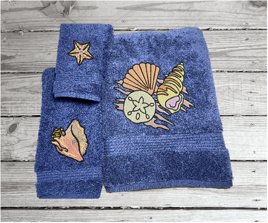 Bue High Quality Luxury Turkish Towels durable soft and absorbent, finished edges with a decorative band. Set has 1 bath towel 27" x 50", 1 hand towel 16" x 27", 1 washcloth 13" x 13". Embroidered with custom sea shells design. You can personalize the towel set with a name and an initial on the washcloth or just the designs. These luxury towels will make a wonderful wedding gift, housewarming gift, or for your own bathroom decor. Borgmanns Creations