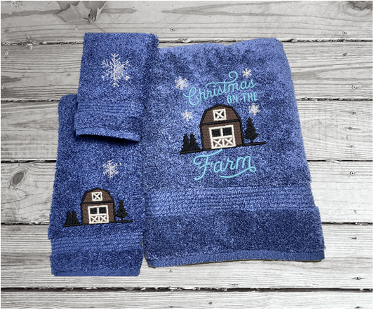 Blue bath towel set, or individual towels, embroidered design of a barn at Christmas time is perfect for the country living family, for that farmhouse decor. This Luxury soft and absorbent Christmas theme towel set of 3 towels 1 bath towel 27" x50", 1 hand towel 16" x 27", 1 wash cloth 13" x 13".  Borgmanns Creations 1