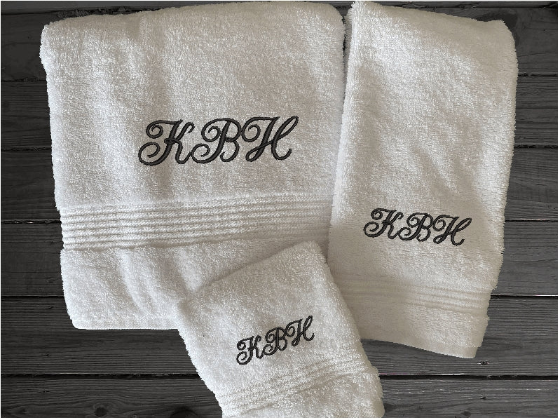 White bath towel set personalized bath towels with embroidered monogram initials. Soft absorbent bath towels, hand towels and washcloths, bath towel - 27" x 50", hand towel - 16" x 27", wash cloth - 13" x 13, "a gift for anyone in the family or a gift for a friend. Monogram towels for that special wedding gift. This font is Anniversary- Borgmanns Creations