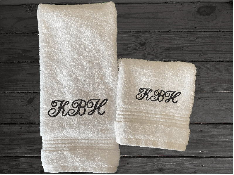 White hand towel and washcloth, personalized bath towels with embroidered monogram initials. Soft absorbent bath towels, hand towels and washcloths, bath towel - 27" x 50", hand towel - 16" x 27", wash cloth - 13" x 13, "a gift for anyone in the family or a gift for a friend. Monogram towels for that special wedding gift. This font is Anniversary- Borgmanns Creations