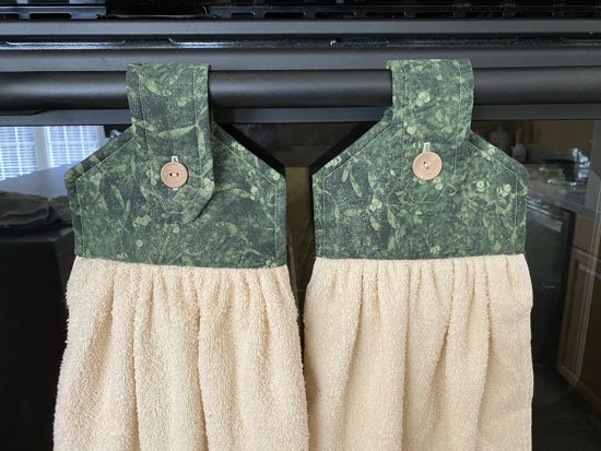 Beige cotton terry towel with green floral material for the top and beige wooden button to fasten loop. Ready to ship. Overall lenght is 21