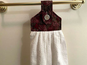 White terry towel over all size of 21 inches, the top has batting between layers of marroon floral cotton material and a button for fastening on oven handle, drawer handle, icebox, shower bar or bathroom hanger. A wonderful way to  have a towel handy at all times.  This item is ready to ship. - Borgmanns Creations -7