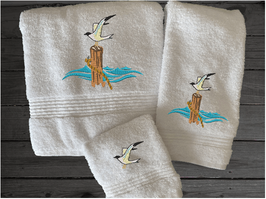 White High Quality Luxury Turkish Towels durable soft and absorbent, finished edges with a decorative band. Set has 1 bath towel 27" x 50", 1 hand towel 16" x 27", 1 washcloth 13" x 13". Embroidered with a custom sea gull design. You can personalize the towel set with a name and an initial on the washcloth or just the designs. These luxury towels will make a wonderful wedding gift, housewarming gift, or for your own bathroom decor. Borgmanns Creations