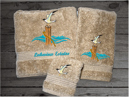 High Quality Luxury Turkish Towels durable soft and absorbent, finished edges with a decorative band. Set has 1 bath towel 27" x 50", 1 hand towel 16" x 27", 1 washcloth 13" x 13". Embroidered with a custom sea gull on a post design. You can personalize the towel set with a name and an initial on the washcloth or just the designs. These luxury towels will make a wonderful wedding gift, housewarming gift, or for your own bathroom decor. Borgmanns Cretions