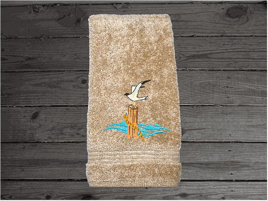 High Quality Luxury Turkish beige hand towel, durable soft and absorbent, finished edges with a decorative band. Set has 1 bath towel 27" x 50", 1 hand towel 16" x 27", 1 washcloth 13" x 13". Embroidered with a custom sea gull on a post design. You can personalize the towel set with a name and an initial on the washcloth or just the designs. These luxury towels will make a wonderful wedding gift, housewarming gift, or for your own bathroom decor. Borgmanns Cretions