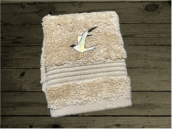 High Quality Luxury Turkish beige washcloth, durable soft and absorbent, finished edges with a decorative band. Set has 1 bath towel 27" x 50", 1 hand towel 16" x 27", 1 washcloth 13" x 13". Embroidered with a custom sea gull on a post design. You can personalize the towel set with a name and an initial on the washcloth or just the designs. These luxury towels will make a wonderful wedding gift, housewarming gift, or for your own bathroom decor. Borgmanns Cretions
