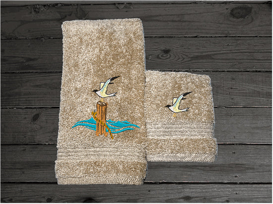 High Quality Luxury Turkish beige hand towel and washcloth, durable soft and absorbent, finished edges with a decorative band. Set has 1 bath towel 27" x 50", 1 hand towel 16" x 27", 1 washcloth 13" x 13". Embroidered with a custom sea gull on a post design. You can personalize the towel set with a name and an initial on the washcloth or just the designs. These luxury towels will make a wonderful wedding gift, housewarming gift, or for your own bathroom decor. Borgmanns Cretions