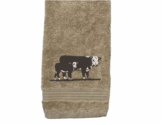 Beige hand towel , Hereford Cow design is just the item you can display with your ranch name embroidered on it, for that farmhouse decor. This Luxury western theme towel set of 3 towels 1 bath towel 27" x 50", 1 hand towel 16" x 27", 1 wash cloth 13" x 13". Personalize the bath towel with a name and initial on the washcloth  - Borgmanns Creations