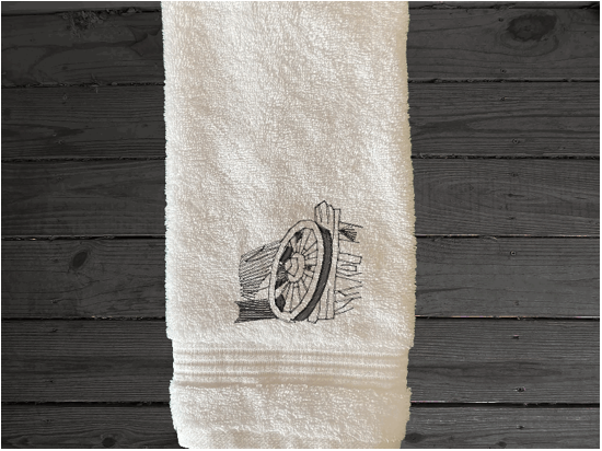White Luxury hand towel, wagonwheel aguenst fence design is the perfect design for the country living family that likes the outdoor life, for that farmhouse decor. This Luxury western theme towel set of set has 3 towels 1 bath towel 27" x 50", 1 hand towel 16" x 27", 1 wash cloth 13" x 13". You can personalize the bath towel with a name and an initial on the wash cloth or just the design - Borgmanns Creations 