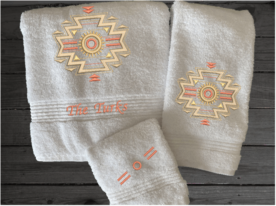 White bath towel set or individual towels, embroidered Southwest Symbol is the perfect design for the western living family, that farmhouse decor. This Luxury western theme towel set 3 towels 1 bath towel 27" x 55", 1 hand towel 16" x 27", 1 wash cloth 13" x 13". You can personalize the bath owel with a name. Borgmanns Creations