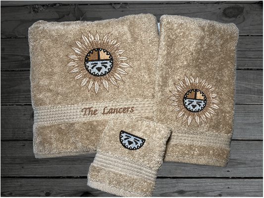 Beige bath towel set or individual towels, embroidered Southwest Sun Symbol is the perfect design for that farmhouse decor. This Luxury towel set, 3 towels 1 bath towel 27" x 50", 1 hand towel 16" x 27", 1 wash cloth 13" x 13". You can personalize the towel set with a name and an initial on the wash cloth or just the designs - Borgmanns Creations