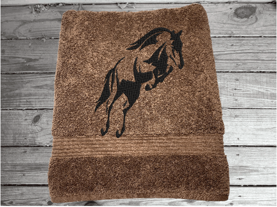 Brown luxury Bath towel, embroidered jumping horse is the perfect design for the horse living family, that English decor. This Luxury horse towel set has  3 towels 1 bath towel, 1 hand towel, 1 wash cloth. You can personalize the towel set with a name and an initial on the wash cloth or just the designs. Borgmanns Creations 3