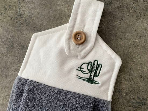 A soft and absorbing hanging bathroom/kitchen towel with button to hang on oven door or drawer handle. 16