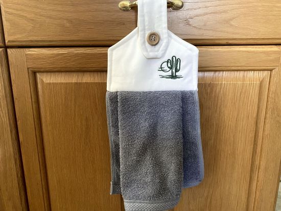 A soft and absorbing hanging bathroom/kitchen towel with button to hang on oven door or drawer handle. 16" x 9 1/2" terry towel with white denim top with batting overall leingth 17 inches perfect gift for mom, for her guests to use. Makes a wonderful housewarming gift, bridal shower, anniversary, Christmas, etc. Borgmanns Creations - 3