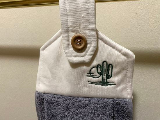 A soft and absorbing hanging bathroom/kitchen towel with button to hang on oven door or drawer handle. 16" x 9 1/2" terry towel with white denim top with batting overall leingth 17 inches perfect gift for mom, for her guests to use. Makes a wonderful housewarming gift, bridal shower, anniversary, Christmas, etc. Borgmanns Creations - 5