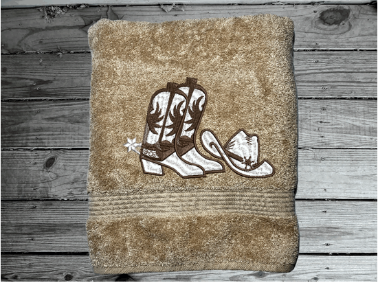 Beige western bath towel, cowboy hat and boots, this Luxury Turkish Towel set has 3 towels  1 bath towel 27" x 50", 1 hand towel 16" x 27", 1 washcloth - 13" x 13" the perfect design for the western farmhouse decor. You can personalize this bathroom towel set will make a wonderful wedding gift.  Borgmanns Creations 