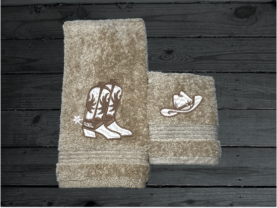 Beige western hand towel and washcloth, cowboy hat and boots, this Luxury Turkish Towel set has 3 towels  1 bath towel 27" x 50", 1 hand towel 16" x 27", 1 washcloth - 13" x 13" the perfect design for the western farmhouse decor. You can personalize this bathroom towel set will make a wonderful wedding gift.  Borgmanns Creations 