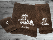 Load image into Gallery viewer, Brown bath towel set or individual towels, cowboy hat and boots is the perfect design for that farmhouse decor. This Luxury western theme towel set 3 towels 1 bath towel 27&quot;x55&quot;, 1 hand towel 15&quot;x28&quot;, 1 wash cloth 13&quot; x 13&quot;. You can personalize the towel set with a name and an initial on the wash cloth or just the designs. Borgmanns Creations 1
