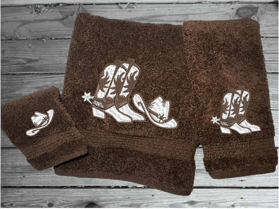 Brown bath towel set or individual towels, cowboy hat and boots is the perfect design for that farmhouse decor. This Luxury western theme towel set 3 towels 1 bath towel 27"x55", 1 hand towel 16"x28", 1 wash cloth 13" x 13". You can personalize the towel set with a name and an initial on the wash cloth or just the designs. Borgmanns Creations