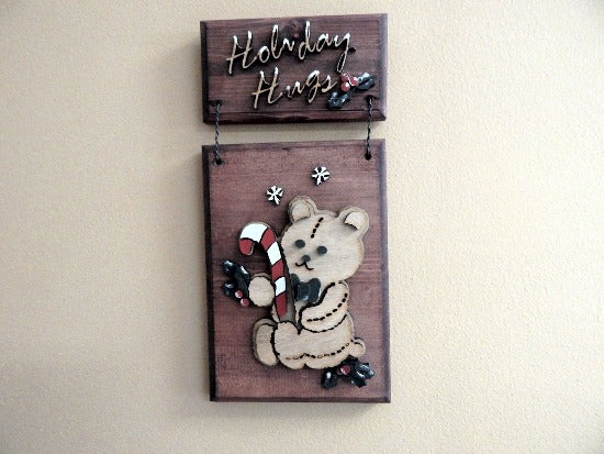 Holiday Hugs wall hanging - laser cut lauan wood  layered - glued to beveled wood with mahogany stain - 2 pieces hung together with wire - painted with acrylic paint - Borgmanns Creations 