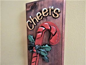 Holiday cheers candy cane layered wood decoration - laser cut luan wood and glued to the base of 1 inch beveled edge wood with mahogany stain -  painted with acrylic paint - Hanging hook on back for easy hanging - Borgmanns Creations 