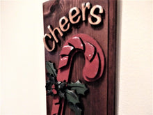 Load image into Gallery viewer, Holiday cheers candy cane layered wood decoration - laser cut luan wood and glued to the base of 1 inch beveled edge wood with mahogany stain -  painted with acrylic paint - Hanging hook on back for easy hanging - Borgmanns Creations 
