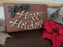 Load image into Gallery viewer, Wood wall hanging - laser cut lauan wood glued to 1&quot; mahogany stained wood - layered wood for holly leaves - a touch of acrylic paint for snow on letters - 11 1/2&quot; x 7 1/4&quot; - Borgmanns Creations 
