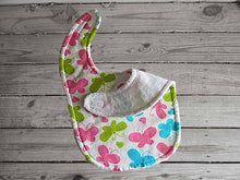 Load image into Gallery viewer, This bib of colorful butterflies made of flannel top and terry cloth backing. The bib 9&quot; from neck to bottom- 8&quot; wide with sticky fasteners, burp cloth- per fold diaper and makes a great gift for the new born baby shower. Keeps the baby dry from those frequent spills - Borgmanns creations - 3
