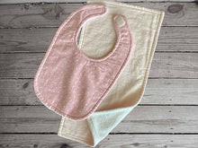 Load image into Gallery viewer, This bib and burp cloth set of white stars on pink background made of flannel top and terry cloth backing, bib 9&quot; from neck to bottom- 8&quot; with sticky fasteners, burp cloth is light pink 16&quot; x 8&quot;wide ,give as a great gift for the new born baby shower, to keep the baby dry from those frequent spills - Borgmanns Creations -1
