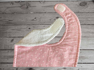 This photo is of the bib and the sticky fasteners, bib and burp cloth set of white stars on pink background made of flannel top and terry cloth backing, bib 9" from neck to bottom- 8" with sticky fasteners, burp cloth is light pink 16" x 8"wide ,give as a great gift for the new born baby shower, to keep the baby dry from those frequent spills - Borgmanns Creations -2