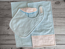 Load image into Gallery viewer, This bib and 2 burp cloths -baby blue color - one burp cloth has decorative strip of material across the end, blue and yellow dots on white background. Made of flannel top and terry cloth backing bib 9&quot; from neck to bottom- 8&quot; wide with sticky fasteners, burp cloth is 16&quot; x 8&quot;  - Borgmanns Creations - 1
