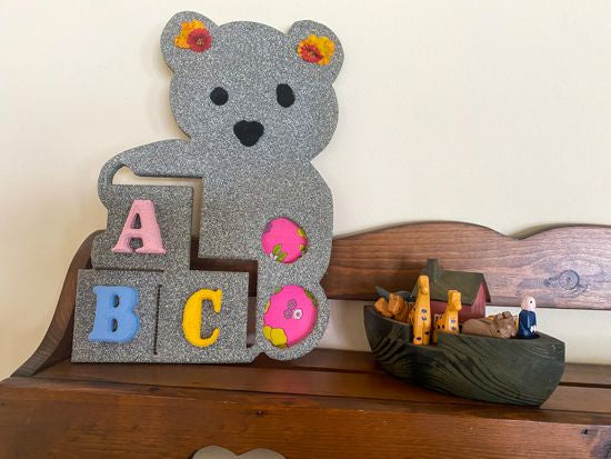 Wood wall art wall hanging, 1/2 MDF board, layered wood, hand painted, with wire, pompom balls, flowers and a hanging hook on the back, 14" H x 10" W x 1/2" D, this cute wood sculpture of a teddy bear will make a great girl baby shower gift for a woodland nursery decor - Borgmanns Creations
