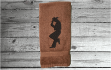 Load image into Gallery viewer, Brown hand towel - embroidered cowboy silhouette - western decor - cowgirl / cowboy gift - personalize it with their name or ranch name -  bathroom or guest bath kitchen or born work towel - Borgmanns Creations 3
