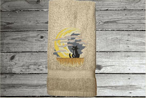 Beige hand towel, beautiful design of a cat watching the moon through the clouds, decorative towel for the bathroom or kitchen to brighten up your Halloween decor. You can personalize it for a gift to a friend or family member. The terry towel, 16" x 27", is soft and absorbent for any bathroom - Borgmanns Creations - 1