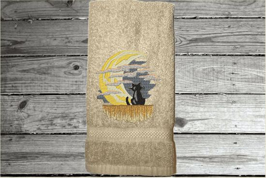Beige hand towel, beautiful design of a cat watching the moon through the clouds, decorative towel for the bathroom or kitchen to brighten up your Halloween decor. You can personalize it for a gift to a friend or family member. The terry towel, 16