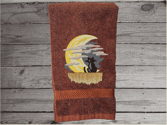 Brown hand towel, beautiful design of a cat watching the moon through the clouds, decorative towel for the bathroom or kitchen to brighten up your Halloween decor. You can personalize it for a gift to a friend or family member. The terry towel, 16" x 27", is soft and absorbent for any bathroom - Borgmanns Creations - 3