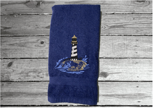 Load image into Gallery viewer, Blue Nautical hand towel - lake home decor - embroidered lighthouse on a cotton terry towel premium soft and absorbent, 16&quot; x 27&quot; - housewarming gift for travelers who live by the sea side or have weekend home by the water, a collector of lighthouses, Borgmanns Creations

